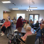 residents of a senior living community gathering at a common area for an activity