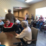 elderly residents gathering at a common area at a senior living community