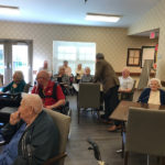 a group of elderly residents of a senior living community enjoying an activity held by Traditions Park Place Senior Living